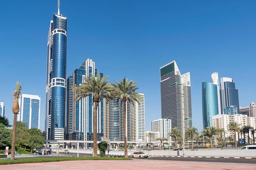 Tall skyscrapers against blue sky in Dubai.