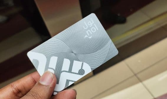 Dubai traveler holding a metro Nol card entry pass.