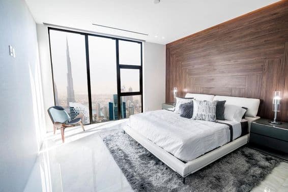 Modern and luxurious bedroom with a view of downtown Dubai.