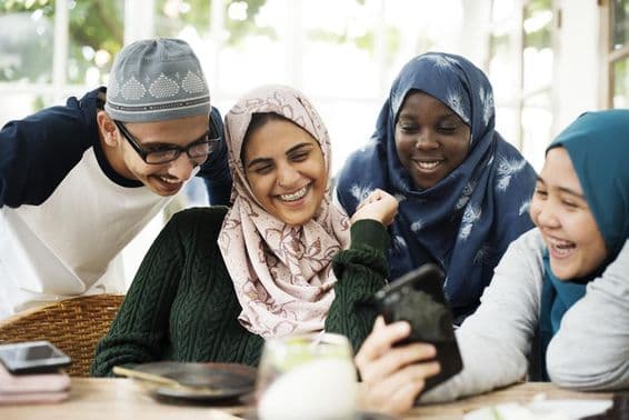 Group of students looking at a lesson on a mobile phone.