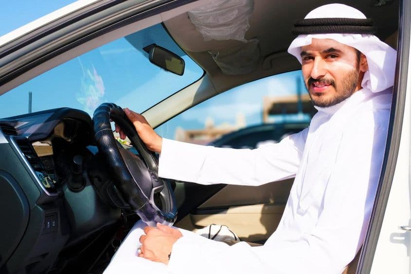 Confident Arab driver smiling.