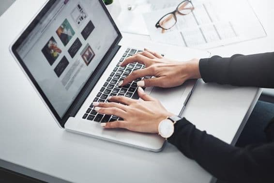 Woman working remotely from home using a laptop.
