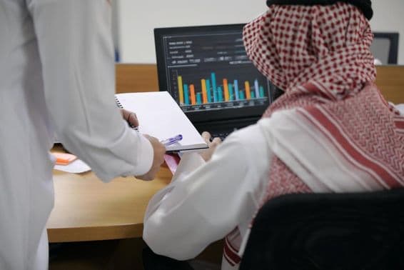 Arab office worker using a laptop.
