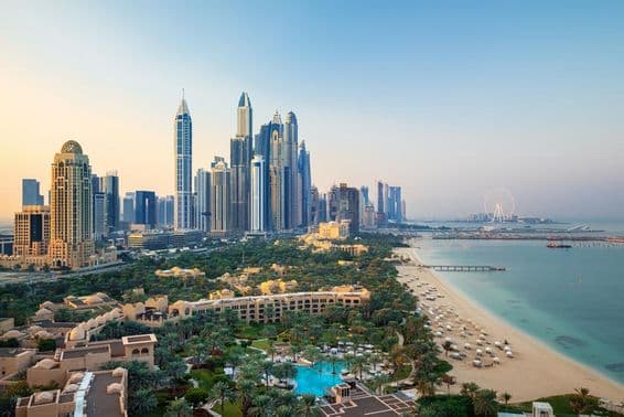 Dubai Marina city skyline and famous Jumeirah beachfront at sunrise.