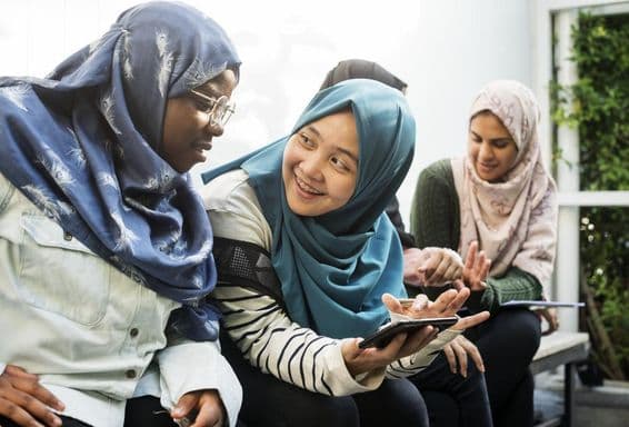 Group of students using mobile phones.