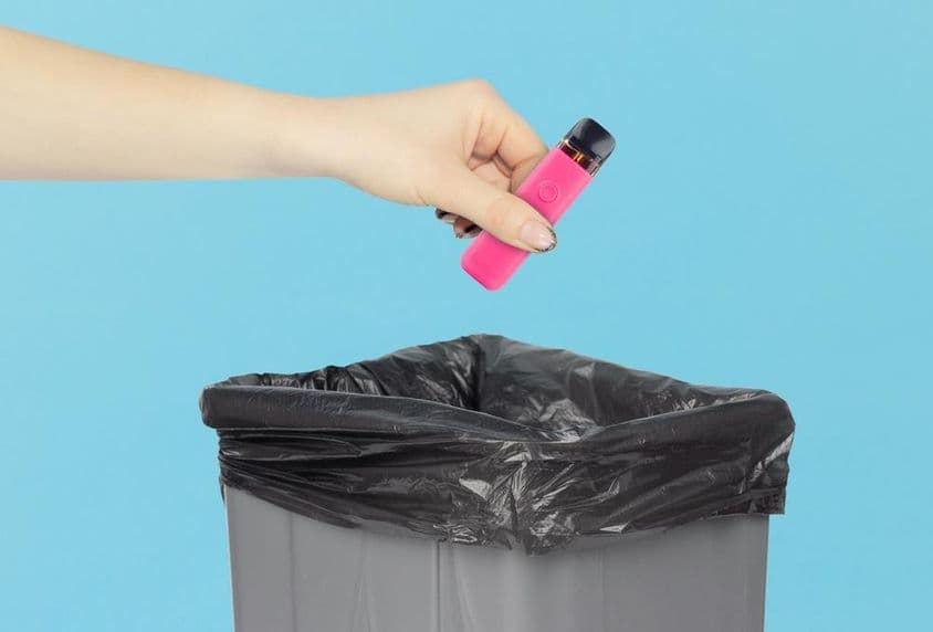 Disposing of an electronic cigarette in the trash.