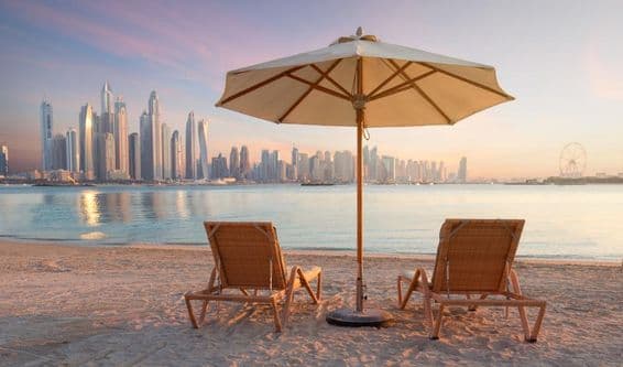 Beautiful beach in Dubai with 2 loungers and one parasol.