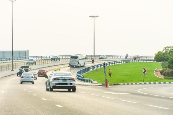 Aman taxi on the road in Sharjah city.