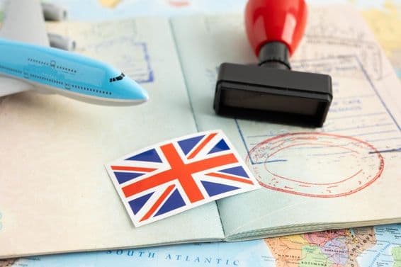 UK flag with a passport stamp.