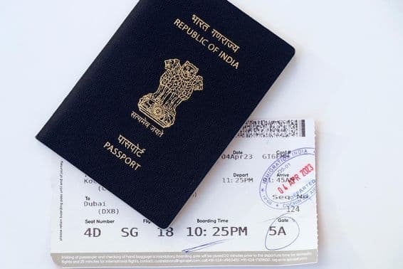 Indian national blue passport with boarding pass.