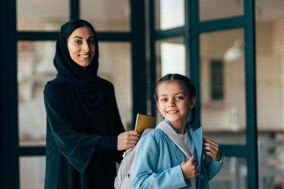 Traditional Arab family from Dubai, young girl heading to school.