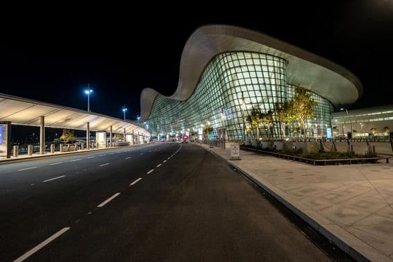 Exterior view of Abu Dhabi's new airport at night.