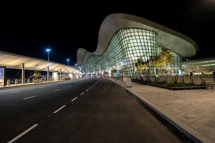 Exterior view of Abu Dhabi's new airport at night.