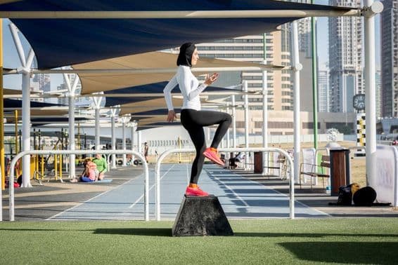 Arab woman exercising, wearing a hijab.