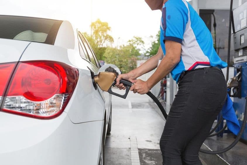 Person refueling car at a Dubai gas station.