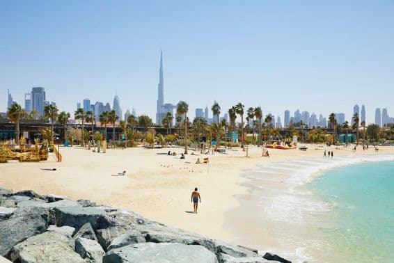 Beach with Dubai skyline in the background, United Arab Emirates.