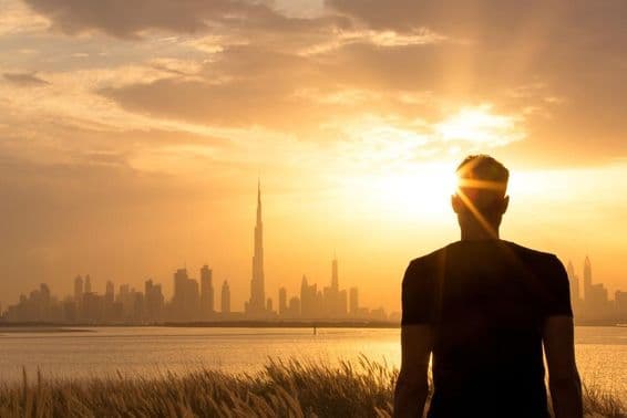 Silhouette of a man watching the beautiful city skyline at sunset.