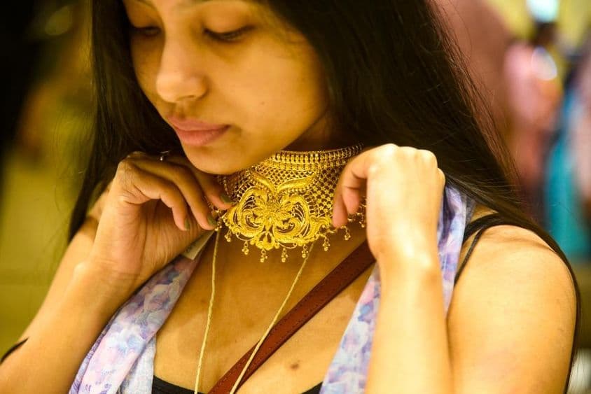 A woman trying on jewelry.