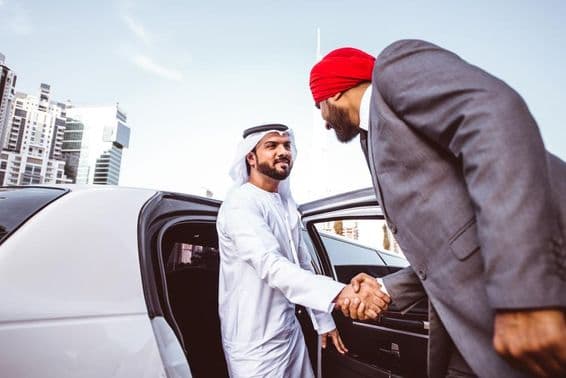 Arab-Indian businessman discussing future plans in Dubai in a limousine.