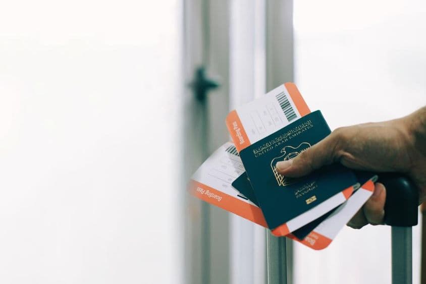A passenger at the airport with a UAE passport and flight ticket.