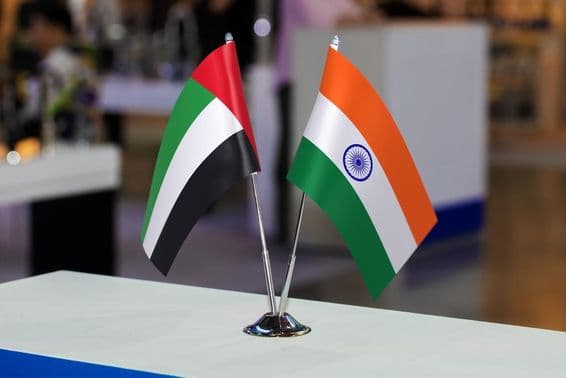The United Arab Emirates and India's two small table flags together at an event.