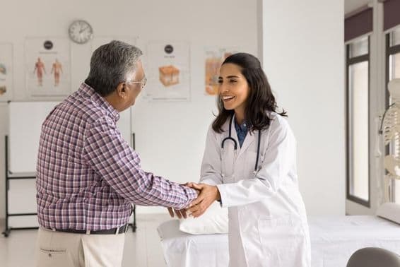 Smiling young female doctor examining a patient.
