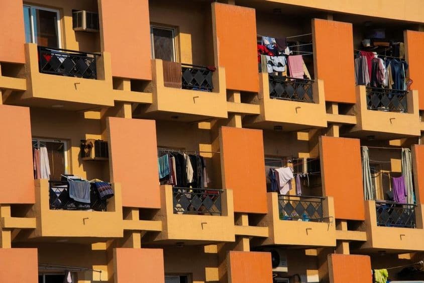 Apartment building in Dubai with clothes drying on balconies.