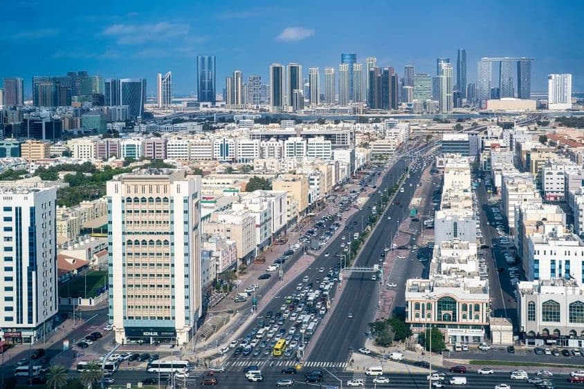 Abu Dhabi, Defence Street traffic and Al Reem Island modern skyscrapers.