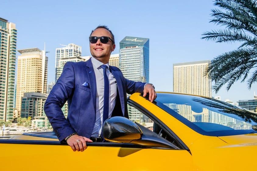 Successful businessman in a yellow convertible car.
