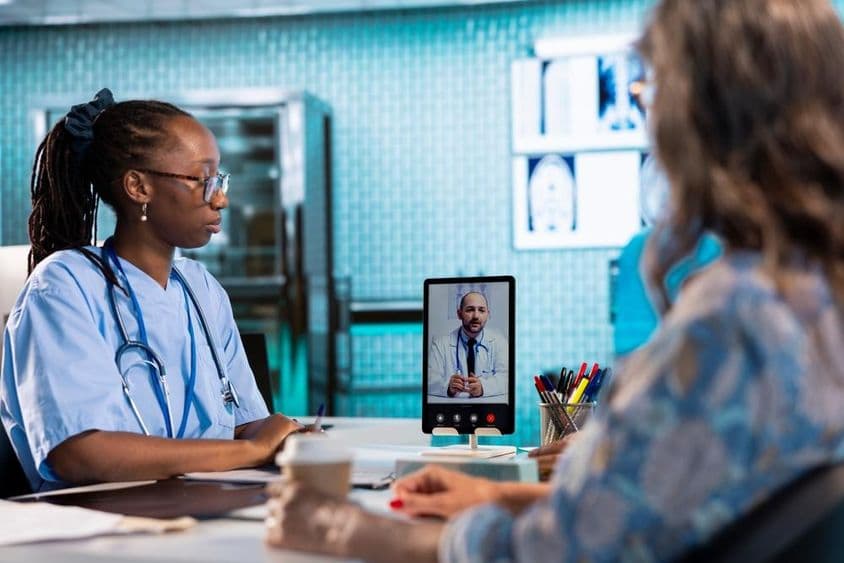 Nurse having a video call with a doctor for remote consultation and telemedicine.