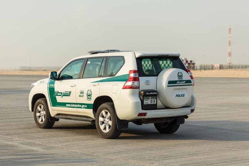 A police car at DUBAI AL MAKTOUM airport.