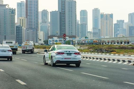 Aman taxi on the road in Sharjah city.