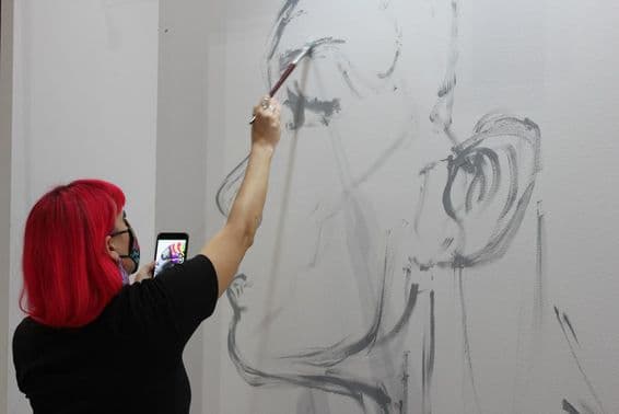 Artist working at the 'World Art Dubai' art fair.