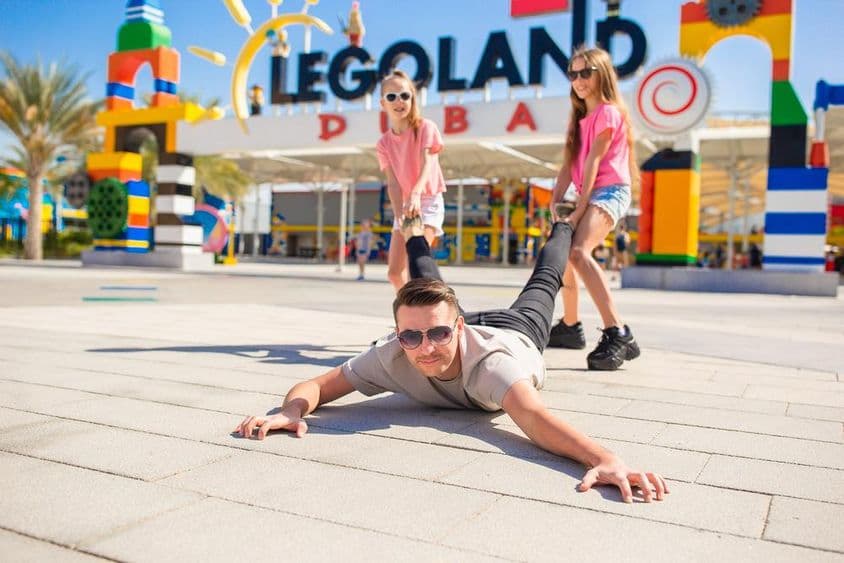 Happy family with father and children in Dubai Legoland.