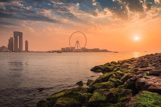 Sunset over Blue Waters Island with the famous Dubai Eye Ferris wheel.