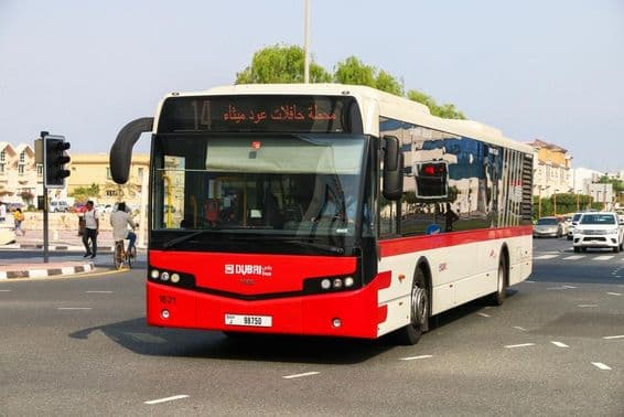 Dubai red city bus on the street.