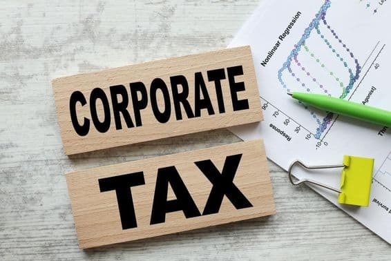 Corporate tax on two wooden cubes.