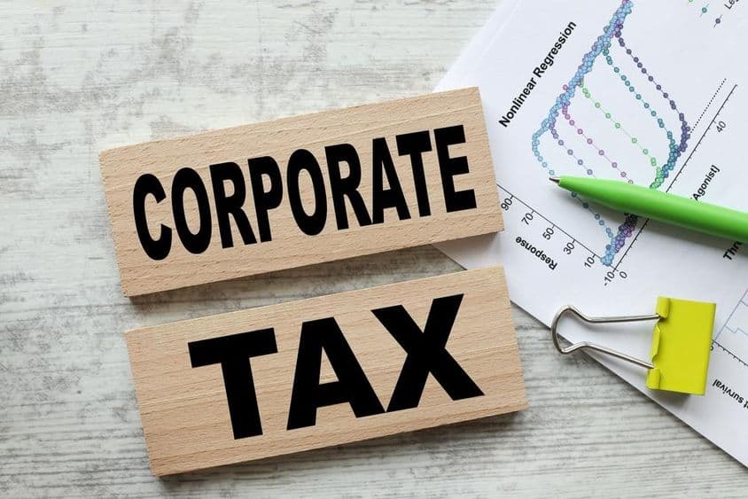 Corporate tax on two wooden cubes.