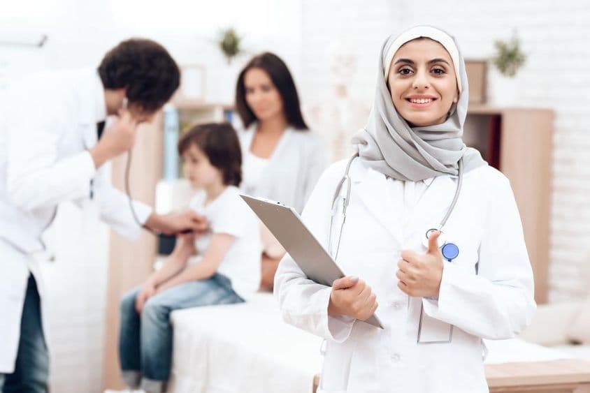 An Arab pediatrician and a young patient.