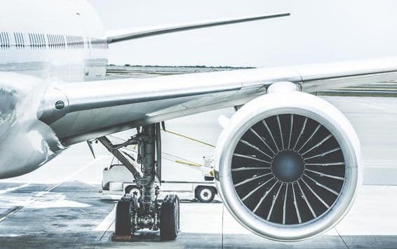 An aircraft engine, wing, and wheels.