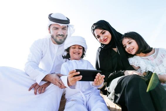 A young child watching a cartoon on a phone.