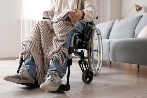 Young man in wheelchair at home.