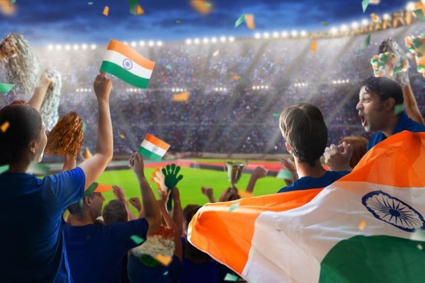 Indian fans watching their team play cricket on the field.