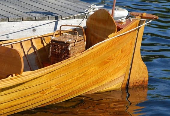 Antique boat with picnic basket in the stern.
