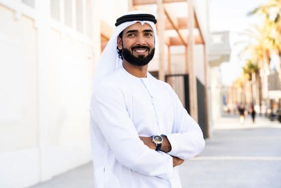 Traditional Arab man wearing Emirati kandura outdoors.
