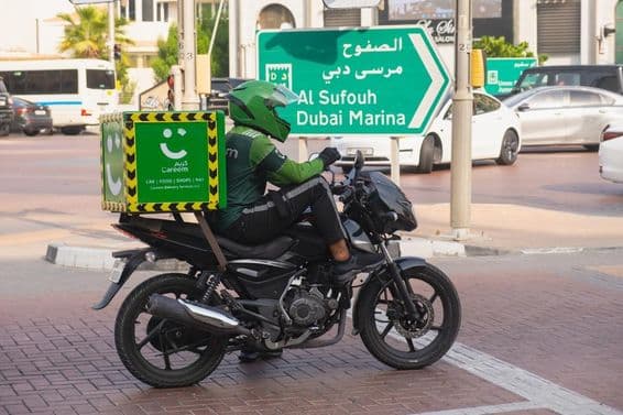 Motorcycle courier from the Careem green delivery service.