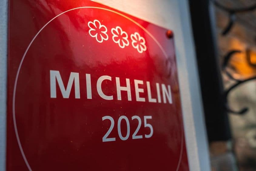 A red, three-star Michelin 2025 memorial plaque.