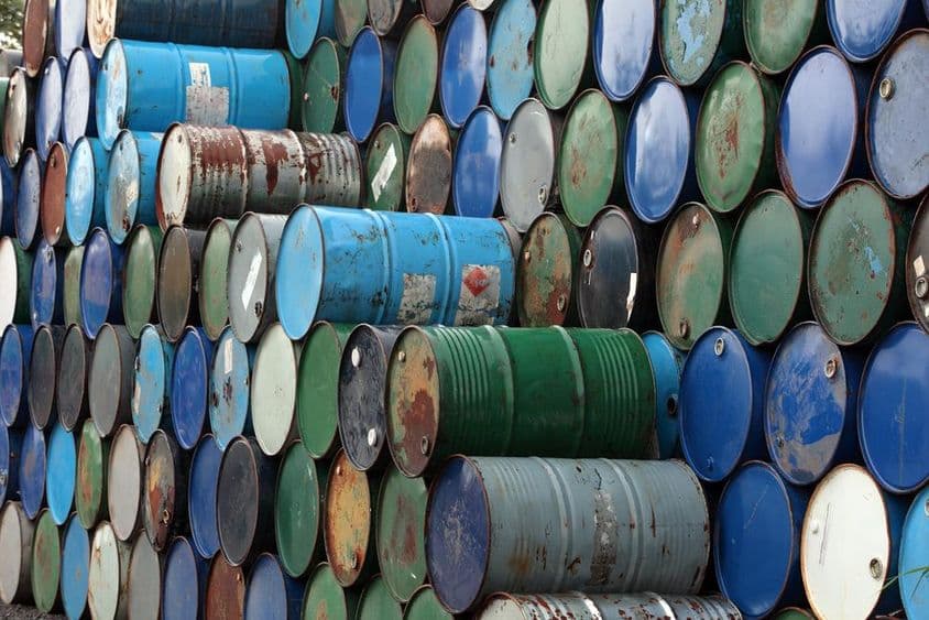 Rusty oil barrels stacked on each other.