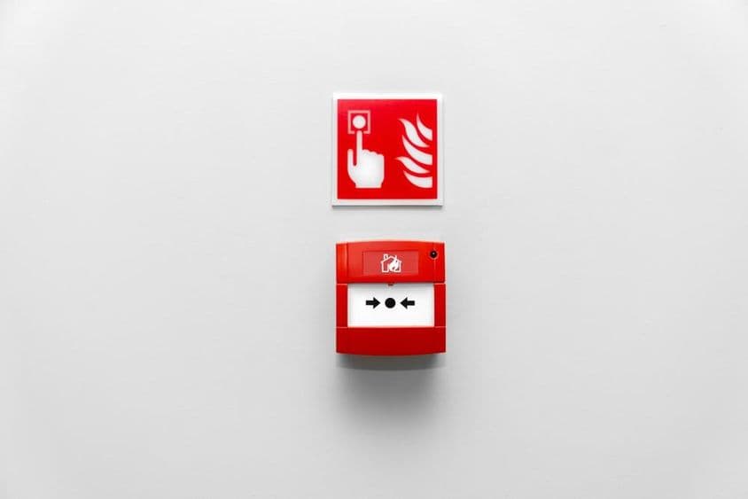 Fire alarm button in a building, red fire alarm button on the wall.