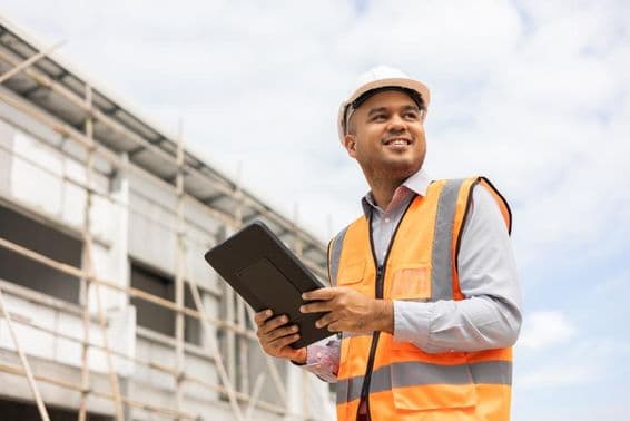 Asian engineer man using tablet to check construction.